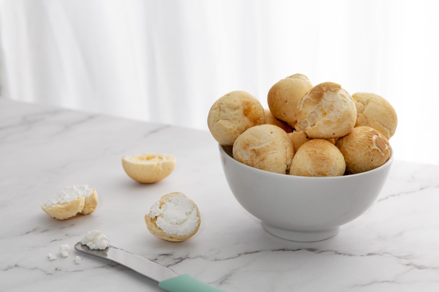Pães caseiros: aprenda diferentes receitas | Foto de tigela com pães de queijo | Atacadão